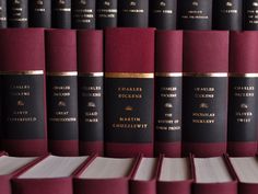 rows of red and black books sitting on top of each other next to each other