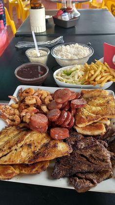 a plate full of food sitting on top of a table next to other plates and bowls