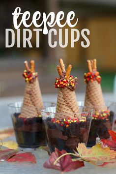 three cones with sprinkles on them sitting in small cups