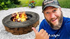 a man pointing at an open fire pit