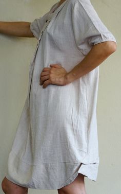 "A boho casual chic short sleeve cotton mix linen dress/tunic with curved hem. - Silhouette- - Loose fit body - Short sleeves - Pleated front dress - Curved hem - Hidden pockets in side seams of the dress - Body length - 94cm/37\" (longest part) Model is 161 cm. tall with the waist of 28\" and the hip of 38\" Status: ready to ship Weight: 302g Measurement: Tunic /dress (approximately) Shoulder: 16.25\" Bust: 42\" **can fit upto bust max38\" Armhole: 22\" Sleeve: 9\" Hip: 48\" **can fit upto bust Cotton Shirt Dress With Pockets For The Beach, Summer Cotton Shirt Dress With Rolled Sleeves, Casual Cotton Shirt Dress With Short Sleeves, Casual Cotton Short Sleeve Shirt Dress, Relaxed Fit Cotton Shirt Dress For Summer, Summer Shift Shirt Dress With Short Sleeves, Short Sleeve Shirt Dress With Pockets For Beach, Beige Cotton Shirt Dress For Daywear, Cotton Dresses With Rolled Short Sleeves