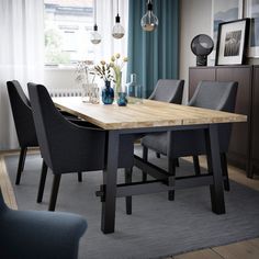 a dining room table with chairs and vases on top of it in front of a window