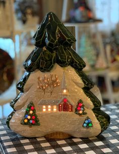 a lighted christmas tree sitting on top of a table