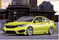 a silver honda accord is parked in front of some buildings