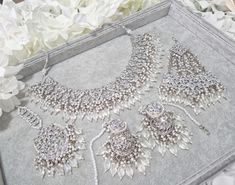 S A V E R A Bridal Set Stunning White Clear Crystal Necklace Set in Antique Silver Finishing with Jhumer, Tikka and Jhumki Earrings If you like this design but would like to customise and get made into any other colour please message me. Allow 6 weeks for ordering. Silver Tikka With Intricate Design For Wedding, Silver Bridal Accessories With Tilla, Silver Bridal Accessories With Tilla For Wedding, Silver Wedding Tikka With Intricate Design, Silver Bridal Sets With Intricate Design For Reception, Festive Bridal Sets With Mirror Work For Wedding, Chandbali Beaded Bridal Necklace For Wedding, Festive Silver Beaded Jewelry Sets, Silver Tilla Bridal Necklace For Wedding