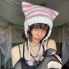 a woman wearing a knitted cat hat