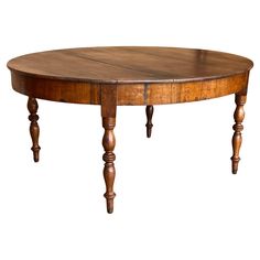 an oval wooden table with two legs on one end and a center piece on the other