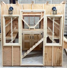 the inside of a house being built with wooden walls and windows on top of it