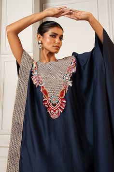 Navy blue silk asymmetric kaftan with floral pearls, beads, thread work and zardosi embroidered yoke. Paired with coordinating solid straight pant. - Aza Fashions Silk Kurta Hand Embellished For Reception, Silk Hand Embellished Kurta For Reception, Anarkali Embellished Kaftan For Festivals, Embellished Kaftan With Traditional Drape For Reception, Bohemian Hand Embellished Kaftan For Parties, Embellished Kaftan For Reception At Eid, Festive Hand Embellished Traditional Kaftan, Festive Maxi Length Kaftan For Reception, Silk Kaftan With Zari Work For Evening