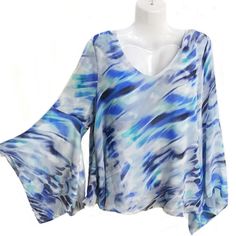 Flowy Layered Top In Blue Hues Sexy Bell Sleeve New With Tags Trendy Light Blue V-neck Blouse, Blue V-neck Top For Night Out, Blue V-neck Blouse For Vacation, Blue Stretch Long Sleeve Blouse, Blue Flowy V-neck Top, Chic Blue Top For Night Out, Blue Stretch Blouse For Night Out, Blue V-neck Tops For Party, Blue V-neck Top For Party