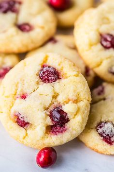 cranberry white chocolate chip cookies are piled on top of each other and ready to be eaten