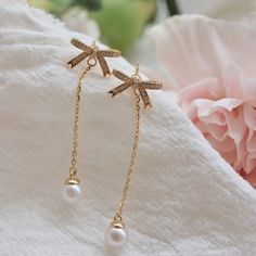 These long tassel earrings exude an unparalleled elegance and sophistication. At the top, a gracefully designed bow adorns the earrings, embellished with sparkling small zircons that twinkle like stars in the night sky. Dangling gracefully from the bottom is a single, natural high-quality pearl, emitting a soft and enchanting glow. The metal accents come in two elegant color options: gold and silver. Both are crafted from high-quality S925 silver, ensuring durability and luxuriousness. The gold Elegant Pearl Drop Tassel Earrings, Elegant Silver Tassel Earrings For Gift, Elegant Pearl Drop Dangle Tassel Earrings, Silver Elegant Tassel Drop Earrings, Elegant Silver Tassel Drop Earrings, Dangle Tassel Earrings With Pearl Drop For Gifts, Silver Tassel Single Earring As Gift, Elegant Dangle Linear Earrings As Gift, Elegant Formal Tassel Drop Earrings