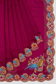 an embroidered pink sari with floral designs on it