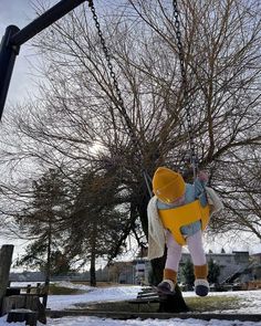 a child on a swing in the snow