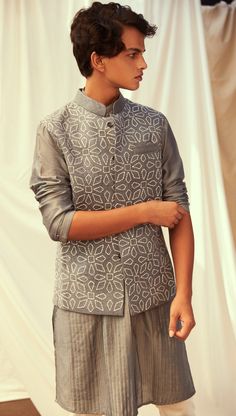 Claudio Bandi is a royal fit for any occasion. A classic grey silk bandi embroidered in motifs inspired by Portugal. Paired with a classic pin tuck kurta in Grey. Composition : Matka Silk Delivery : 5 weeks as the product is hand crafted. Check Size Guide or choose MySize for free customisation (All Sizes above XL can be made at 15% additional cost) For more information and sizes please contact fabiliciousfashion@gmail.com or visit our Copenhagen studio. Elegant Chanderi Nehru Jacket With Traditional Drape, Elegant Chanderi Nehru Jacket For Diwali, Elegant Nehru Jacket With Traditional Drape In Chanderi, Elegant Chanderi Bandhgala For Festive Occasions, Elegant Festive Chanderi Bandhgala, Elegant Chanderi Bandhgala For Transitional Season, Fitted Cotton Silk Bandhgala With Intricate Embroidery, Elegant Chanderi Nehru Jacket For Festive Occasions, Elegant Chanderi Nehru Jacket For Festivals