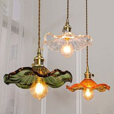 three glass lights hanging from the ceiling