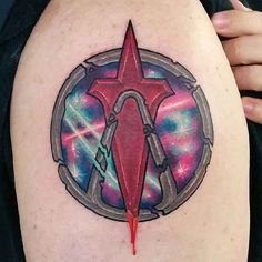 a woman's arm with a tattoo on it that has an image of a spaceship in the center