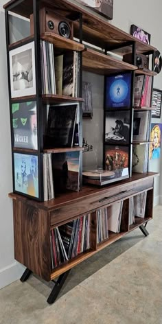 an entertainment center with various records on it