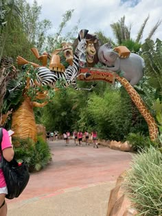 the entrance to disney's animal kingdom is decorated with zebras and giraffes