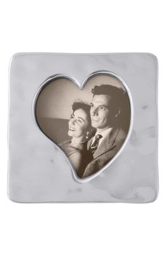 a marble photo frame with an image of a man and woman in the shape of a heart