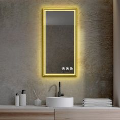 a bathroom with a sink, mirror and lights on the wall above it's counter