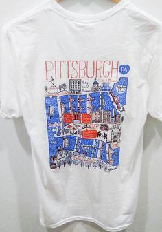 Show off your team pride in this Pittsburgh White Julie Gash Short Sleeve T Shirt! This Pittsburgh Local Stuff Shop Short Sleeve Tee features a screen print graphic. Make sure everyone knows you root for the Pittsburgh with this White Pittsburgh Local Stuff Shop T Shirt. The Steel City! Short sleeve, Crew neck, Relaxed fit, Unisex, Screen printed graphic, 100% Cotton Short Sleeve Graphic Print Shirt For Fans, Graphic Print Short Sleeve Shirt For Fan Gear, Cotton T-shirt With Front Print For Fans, Front Print Cotton T-shirt For Fan Gear, Collegiate Short Sleeve Shirt With Graphic Print, White T-shirt With Front Print For Sports Events, Collegiate White T-shirt With Sublimation Print, Pre-shrunk Graphic Tee For Fan Gear, White Graphic Print T-shirt For Game Day