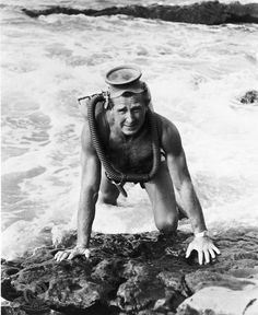 an old photo of a man diving into the ocean