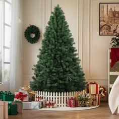 a christmas tree in a living room with presents on the floor