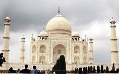 people are standing in front of a white building