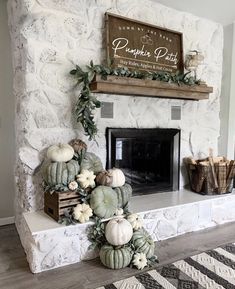 a fireplace decorated with white pumpkins and greenery next to a sign that says pumpkin patch