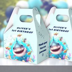 Take your boy's birthday party to the next level with these under the sea Jawsome party favor boxes! Featuring a cute and happy shark, these boxes are the perfect addition to create a memorable celebration. Customize the text to add a personal touch and ensure your guests leave with a little piece of the underwater sharktastic fun! :) - Kate Eden Art. Baby Shark Birthday Party Boy, Box Design Ideas, Baby Shark Birthday Party, 1st Birthday Party Favors, Happy Shark, Birthday Pool Party, Birthday Party Boy, Baby Shark Birthday, Baby Boy 1st Birthday Party