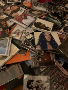 a pile of various records and cds on top of each other