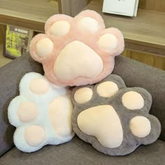 two stuffed animals sitting on top of a couch next to each other in front of a book shelf