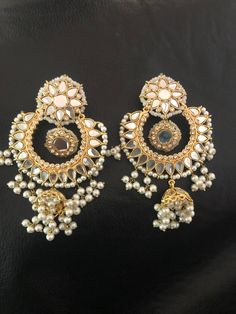 A stunning chand Bali and small jhumki earrings made with sheesha kundan stones and 22 kt gold plated. Perfect for any special special event. Made to order and shipping time 4-6 weeks. Gold Plated Meenakari Chandelier Earrings For Festivals, Festive Gold Plated Meenakari Chandelier Earrings, Gold Plated Meenakari Chandelier Earrings For Weddings, Chandbali Chandelier Earrings With Mirror Work For Festivals, Festive Chandbali Chandelier Earrings With Mirror Work, Kundan Pearl Earrings With Stone Work For Festivals, Festival Chandbali Chandelier Earrings With Mirror Work, Gold Jhumkas With Mirror Work For Diwali, Meenakari Gold Plated Earrings For Party