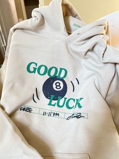 Good Luck 8 Ball Hoodie Pullover hoodie material is 50/50 cotton and polyester. Each item is uniquely printed and designed by me. Black/Green ink on Beige Clothing Unisex Sizing, S, M, L, XL Available (Message me for XXL+ Sizing) Wash instructions: Turn inside out, wash with cold water and delicate setting. Air dry preferred. Follow specific care instructions to ensure the longevity of the design for all handmade items. Check out my Instagram and Depop for customer photos and reviews. Message me Cute Senior Hoodies, Words On Hoodies, Original Hoodie Design, 8 Ball Sweatshirt, Cute Crewneck Sweatshirt Design, Disco Ball Clothes, Christmas Gift Ideas Clothes, Graphic Hoodie Design Inspiration, Trendy Things 2024