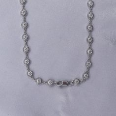 This exquisite 3 3/4 Carat round moissanite diamond necklace features a delicate link chain and a bezel-set design. Expertly crafted with lab-created diamonds in 10K or 14K solid gold and 925 sterling silver, this piece radiates luxury and sophistication. The perfect addition to elevate any outfit. Model No : CSSN1523 Silver Hand Set Round Diamond Necklace, Silver Hand Set Diamond Necklace, Classic Bezel Set Tennis Necklace For Anniversary, Classic Bezel Set Round Tennis Necklace, Silver Moissanite Round Diamond Necklace, Silver Moissanite Necklace With Round Diamond, Round Moissanite Diamond Necklace In Silver, Classic Round Bezel Setting Tennis Necklace, Classic Tennis Necklace With Bezel Setting For Anniversary