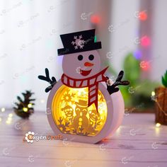 an illuminated snowman is sitting on the table