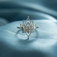 .925 sterling silver Designer's Notes This sterling silver Lotus Ring is named for the Sanskrit word for lotus, "पद्मा" or "padma." The Lotus is the most sacred flower, symbolizing ultimate beauty and new beginnings. This most beautiful of flowers performs a little miracle every day as it grows out of the mud to bloom so beautifully. The mud represents the struggles of life, the blooming is your strength in overcoming the struggle and thriving.It's a perfect self gift or gift for a friend as a r Spiritual Sterling Silver Flower Ring, Spiritual Sterling Silver Flower Jewelry, Spiritual Sterling Silver Flower Shaped Jewelry, Adjustable Spiritual Flower Ring For Promise, Sterling Silver Spiritual Flower Ring, Silver Spiritual Toe Ring Jewelry, Silver Sterling Flower Ring For Promise Occasion, Spiritual Silver Toe Ring Jewelry, Spiritual Flower Rings For Anniversary