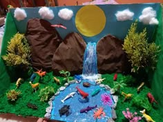 this is an image of a cake made to look like a waterfall and fish pond