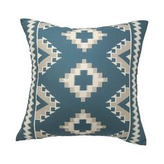 a blue and white pillow with an intricate design on the front, featuring geometric shapes