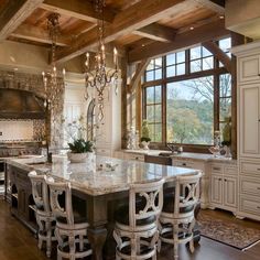 a large kitchen with an island and chandelier