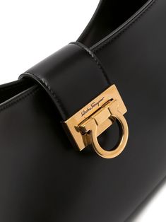 Trifolio shoulder bag from SALVATORE FERRAGAMO featuring adjustable shoulder strap, matte finish, gold-tone hardware, engraved logo, foldover top, main compartment, internal zip pocket and Gancini plaque. Size Info UNI Color Detail Black Made In Italy Material Calf Leather 100% Season One Fall-Winter Season Two Fall-Winter Product bags.. Brand Ferragamo Size And Fit Width 11,81 in / 30 cm Height 7,48 in / 19 cm Depth 2,76 in / 7 cm Handle 9,84 in / 25 cm Ferragamo Wallet, Sea Clothes, Ferragamo Bag, Luxury Designer Handbags, Large Shoulder Bags, Sand Beige, Engraved Logo, Leather Slides, Beauty Items