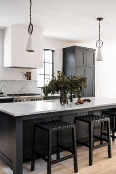 a large kitchen island with stools next to it