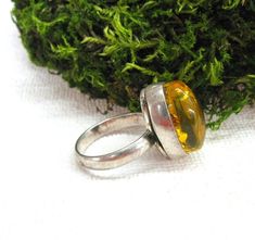 Baltic Amber Statement Ring in perfect vintage condtion. Natural yellow amber oval cabochone is set in silver plated ring. Women's size 9 ( US ), J 1/2 ( UK and Australia ), 19 ( Europe ). The stone measurements: 12 mm wide, 18 mm long and 9 mm thick. You can see the ring from all sides, please view all 5 photos. This eye catching cocktail ring is made for a woman with large finger size. Please note: this jewelry piece is one of a kind, the size is not adjustable. This collectible ring will make Vintage Cabochon Rings For Gifts, Vintage Cabochon Rings As Gift, Vintage Oval Cabochon Ring For Gift, Vintage Oval Cabochon Ring As A Gift, Vintage Oval Cabochon Ring As Gift, Yellow Oval Cabochon Ring For Gift, Handmade Retro Rings As Gift, Handmade Amber Oval Cabochon Rings, Vintage Oval Ring As A Gift