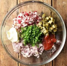 the ingredients for this dish are mixed together in a glass bowl on top of a wooden table