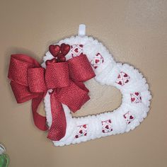 a heart shaped wreath hanging on the wall