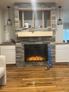 a living room with a fire place in the center and some cabinets on either side