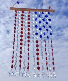 an american flag wind chime hanging in the air with stars and beads on it