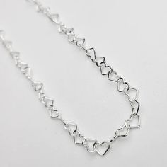 This sweet heart bracelet comes in sterling silver and 14k yellow gold so it makes for a lasting keepsake. Featuring a chain made of dainty little heart shaped links that measure approximately 3.4mm wide. Perfect as a gift or treat yourself, the bracelet is adjustable in size as you can easily make it a smaller fit by attaching the clasp to any link on the chain. Secures with an easy-to-use lobster clasp and the longest fit is 7.5 inches. This chain is also offered in our permanent jewelry line. Sterling Silver Double Heart Bracelet For Everyday Wear, Everyday Double Heart Sterling Silver Bracelet, Adjustable Delicate Sterling Silver Heart Bracelet, Everyday Sterling Silver Double Heart Bracelet, Everyday White Gold Sterling Silver Heart Bracelet, Dainty Sterling Silver Bracelet For Valentine's Day, Sterling Silver Heart Bracelet For Everyday, Dainty Heart Bracelet In Sterling Silver White Gold, Dainty Silver Heart Chain Bracelet