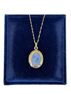 Genuine blue carved agate Mother-Child cameo locket necklace. A gift any Mother will love-a sweet, genuine cameo carved from agate. The pendant is a neoclassical woman and child against a blue background. This is the real thing - carved from agate stone, and is framed in a 14k yellow gold oval locket setting that opens to hold two photos. The locket comes on a new 14k- 18 inch chain. ERA - Circa 2019 METAL / MATERIAL - 14k Yellow Gold, Agate, 14k gold chain  MARKING / HISTORY - Locket is marked Blue Engraved Necklace For Keepsake, Oval Cameo Keepsake Jewelry, Classic Cameo Necklace For Gift, Classic Cameo Necklace As Gift, Oval Cameo Necklace Keepsake, Oval Cameo Necklace For Keepsake, Elegant Oval Cameo Locket Necklace, Victorian Oval Necklace Keepsake, Oval Blue Locket Necklace